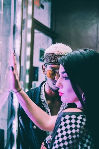 man and woman near clear glass window