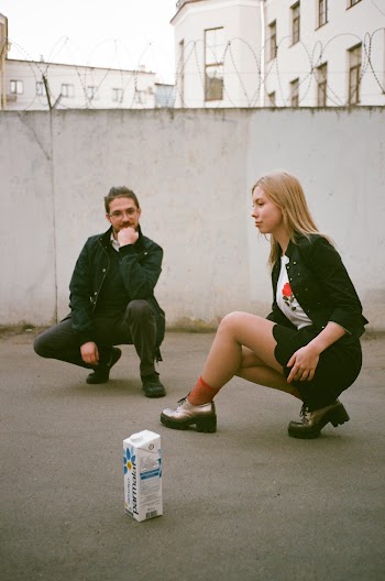 Man and Woman Near Concrete Wall