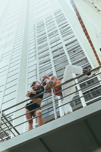 man and woman near gray metal hand rail