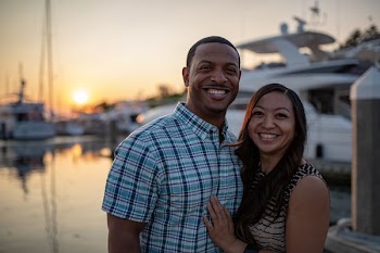 man and woman near white yacht