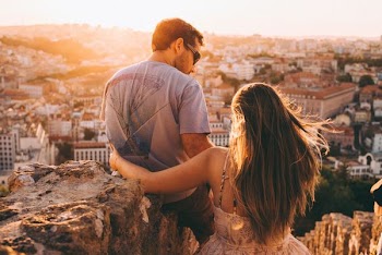 man and woman on top of cliff