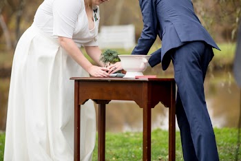 Man and Woman Placing a Bonsai Plant in Pot