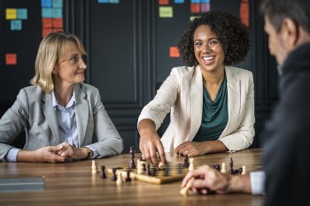 Man and Woman Playing Chess Inside Building