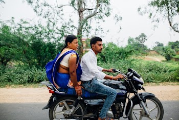 Man and Woman Riding on Motorcycle