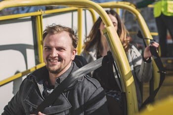 Man and Woman Riding on Yellow Framed Cart