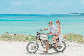 Man and Woman Riding Standard Motorcycle