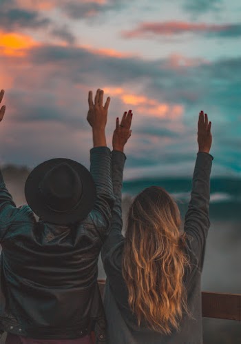 Man And Woman Rising Both Arms