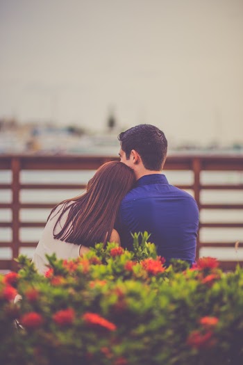 Man and Woman Siting Front of Sea