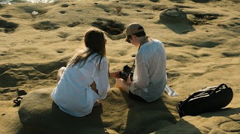 Man and Woman Siting on Rock