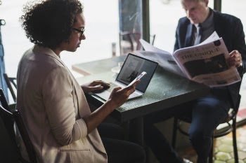 Man and Woman Sitting in Front of Black Table