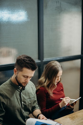 Man and Woman Sitting near the Table