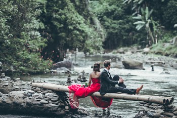 Man And Woman Sitting On Bamboos