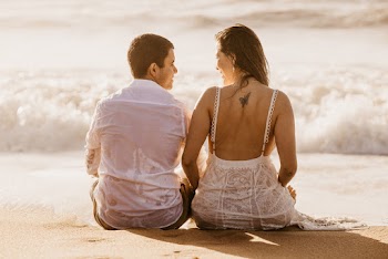 Man and Woman Sitting on Beach