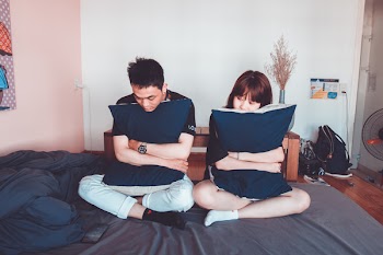 Man and Woman Sitting on Bed