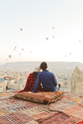 Man and Woman Sitting on Cushion