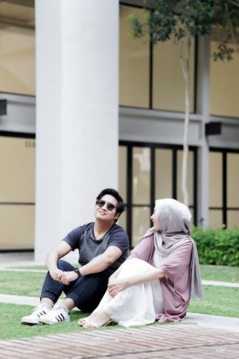 Man and Woman Sitting on Grass