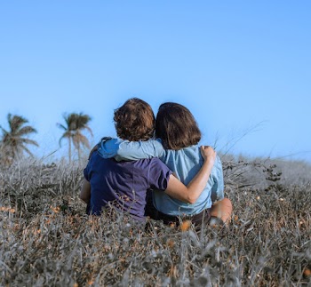 Man and Woman Sitting on Grass