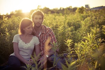 man and woman sitting on grass field at daytime
