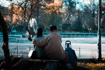 man and woman sitting on pack