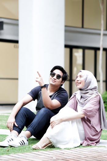 Man and Woman Sitting on Pavement Having Conversation