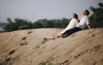 Man and Woman Sitting on the Sand