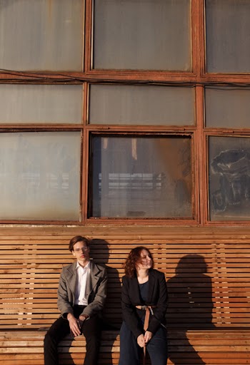 Man and Woman Sitting on Wooden Bench