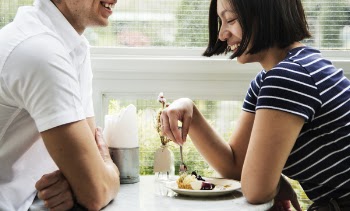 Man and Woman Sitting While Facing Each Other