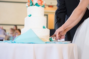 Man And Woman Slicing 3-tier Cake