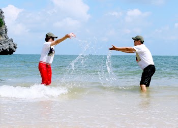 Man And Woman Splashing Water To Each Other 