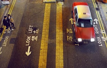 man and woman standing at the right side of the street