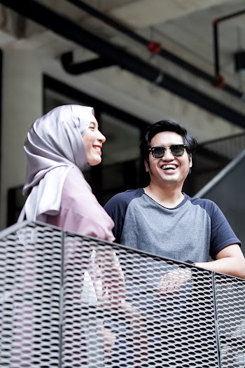 Man and Woman Standing Beside Balustrade