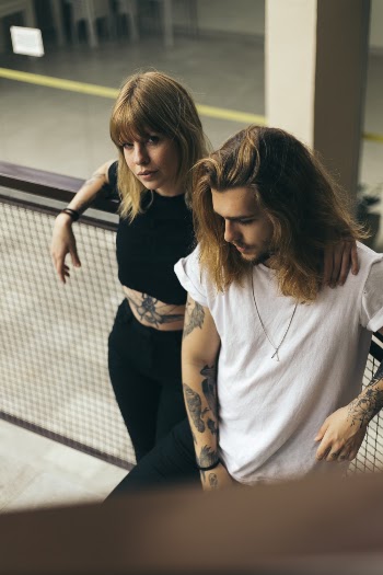 Man and Woman Standing Beside Fence