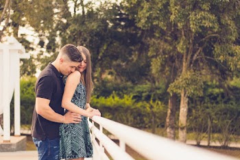 Man and Woman Standing Beside Handrail Near Trees