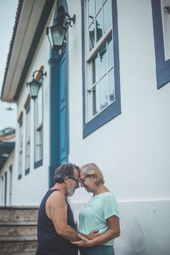 Man and Woman Standing Beside House