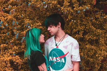 Man and Woman Standing Beside Plant