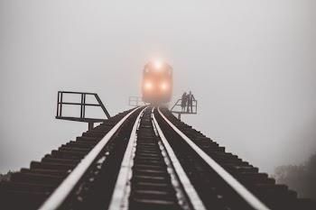 man and woman standing beside trailway