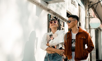 Man and Woman Standing Beside Wall