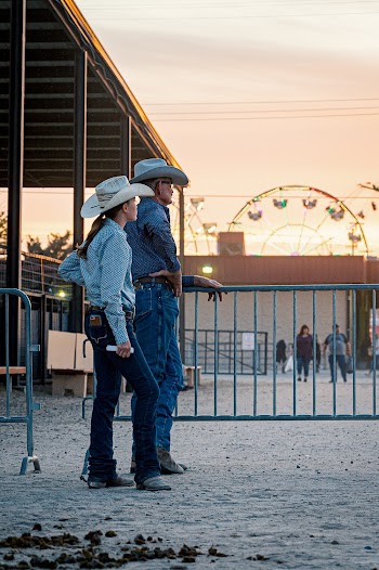 Man And Woman Standing By A Fence