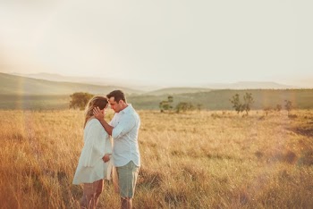 Man and Woman Standing Face to Face in Brown Grass Field