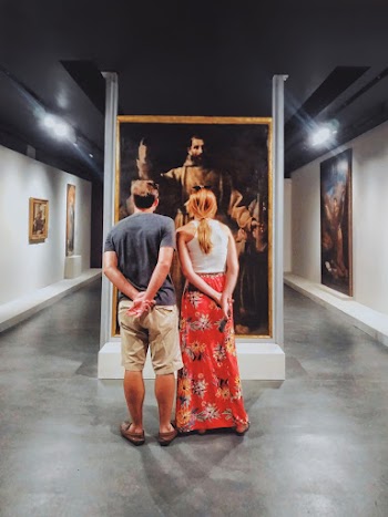 Man and Woman Standing Facing on Man Wearing Brown Robe Suit Photo