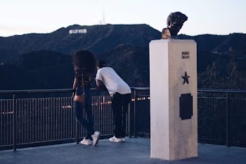 Man and Woman Standing Near Black Metal Railings