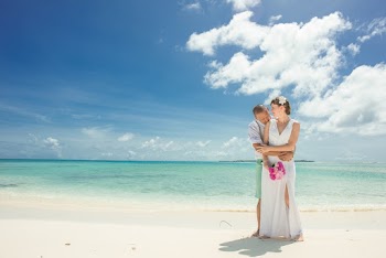 Man And Woman Standing Near Body Of Water