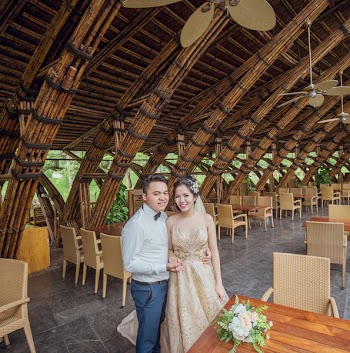 Man and Woman Standing Near Brown Wooden Table