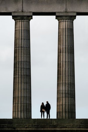 man and woman standing near monument