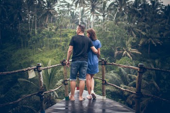 Man and Woman Standing on Hanging Bridge