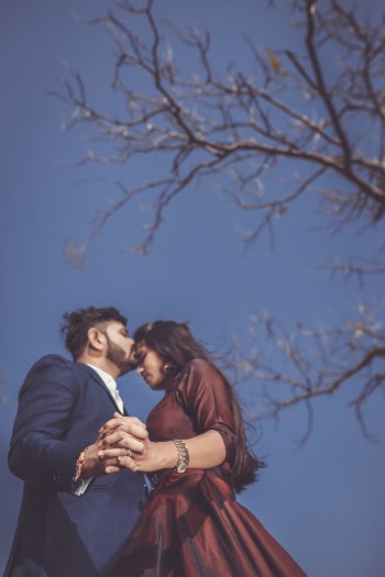 Man and Woman Standing Outside Near Bare Tree