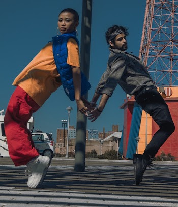 Man and Woman Tiptoeing on Street