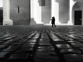 Man and Woman Walking on Empty Street