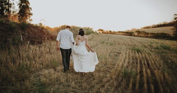 Man and Woman Walking on Field