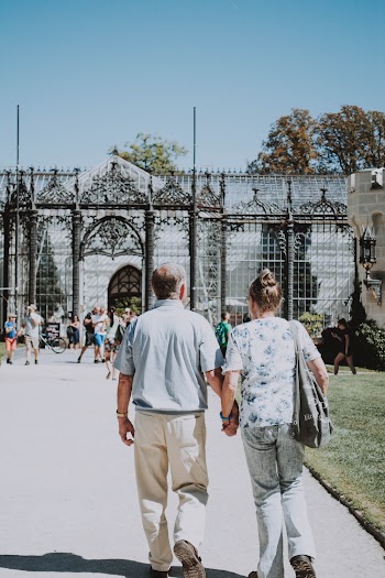 Man and Woman Walking on Pavement